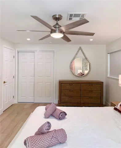 a bedroom with a bed a window and a chandelier