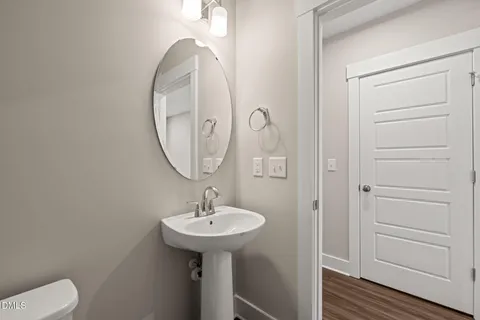 a bathroom with a sink toilet and a mirror