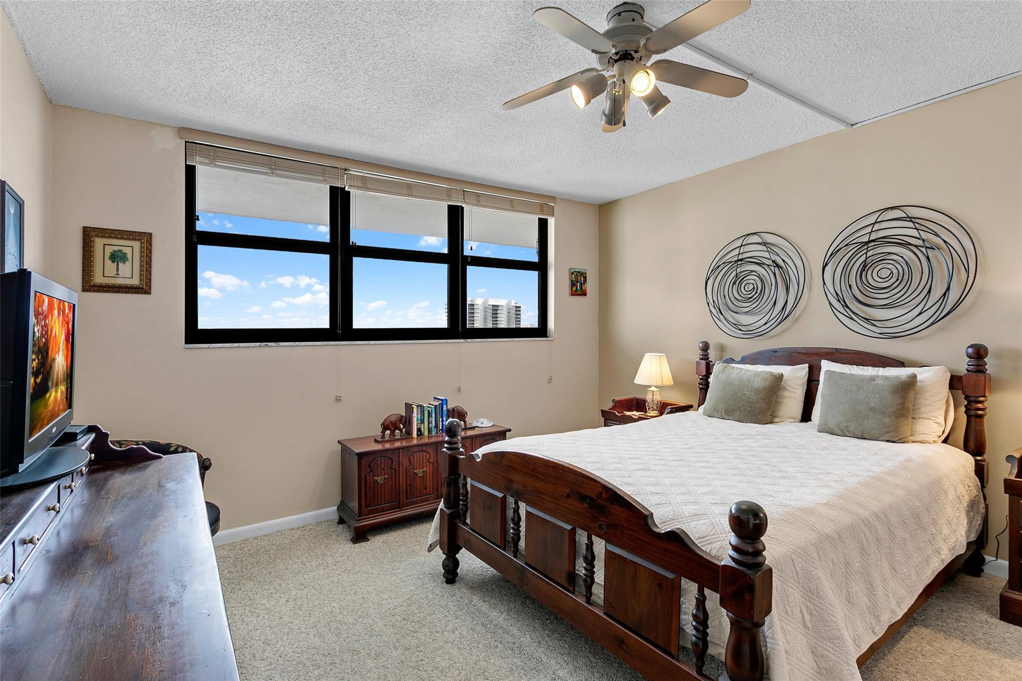 1401 North Riverside Drive, Unit PH 1502 Pompano Beach, FL 33062 - Photo 16 of 32 a bedroom with a bed and a chandelier