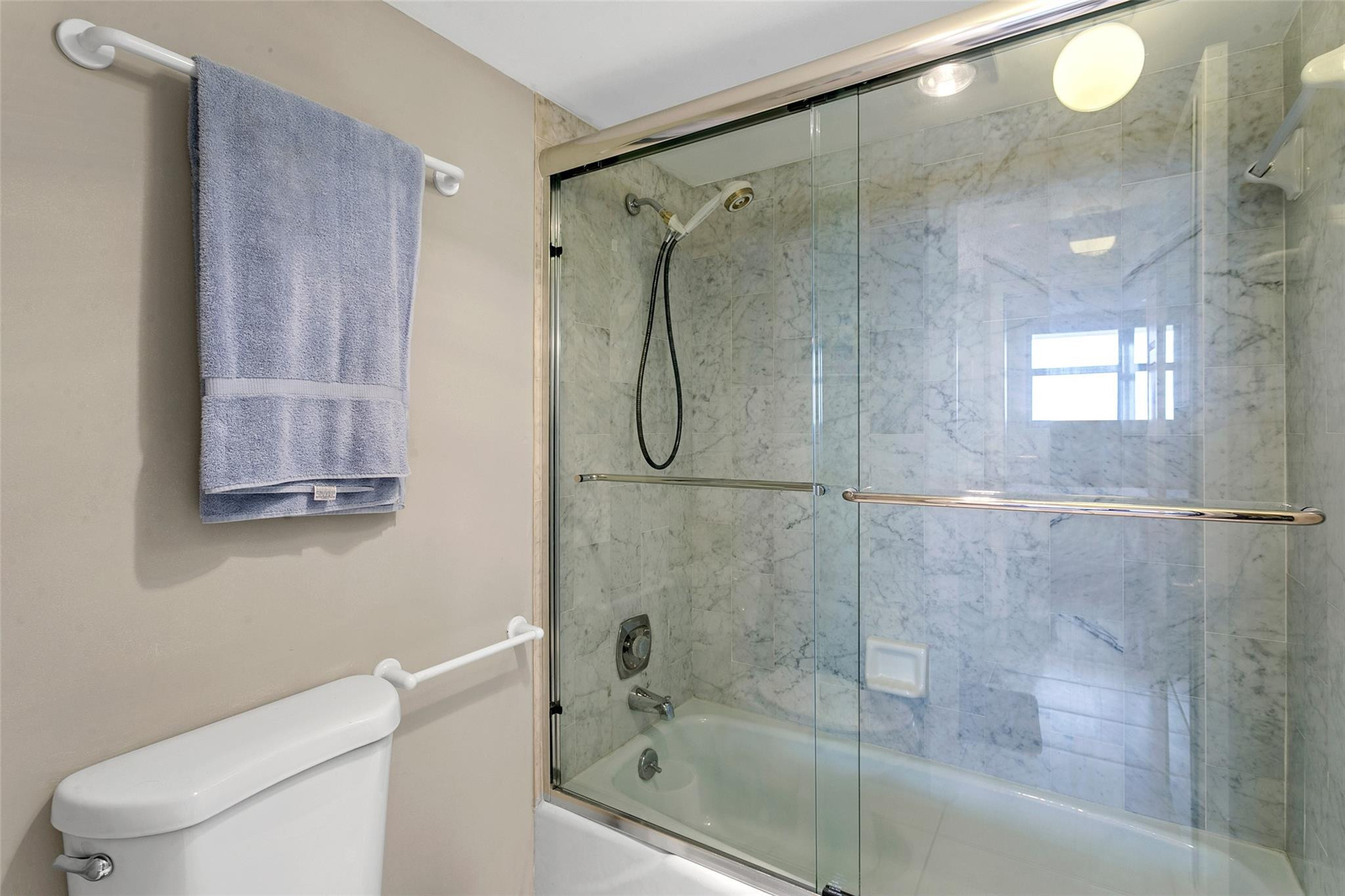 1401 North Riverside Drive, Unit PH 1502 Pompano Beach, FL 33062 - Photo 18 of 32 a bathroom with a glass shower door