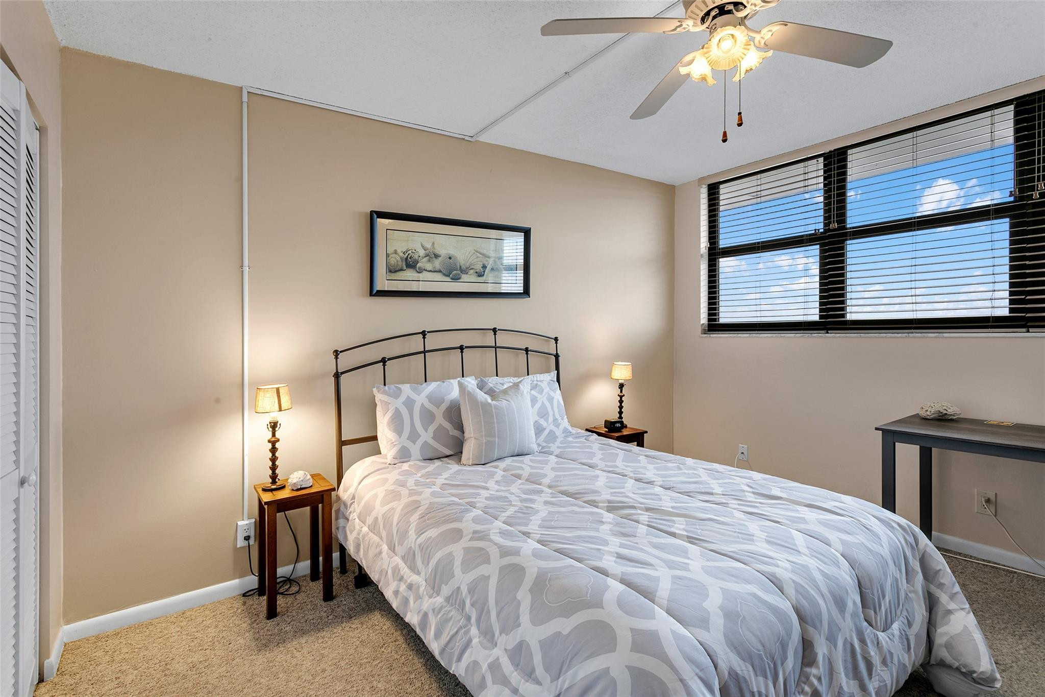 1401 North Riverside Drive, Unit PH 1502 Pompano Beach, FL 33062 - Photo 19 of 32 a bedroom with a bed and a chandelier