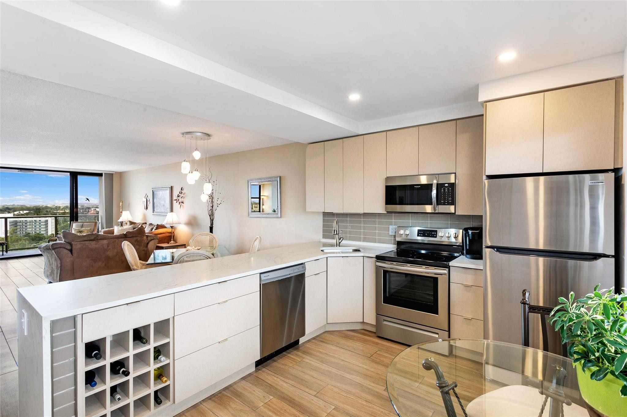 1401 North Riverside Drive, Unit PH 1502 Pompano Beach, FL 33062 - Photo 4 of 32 a kitchen with stainless steel appliances a stove a sink a refrigerator a center island and furniture