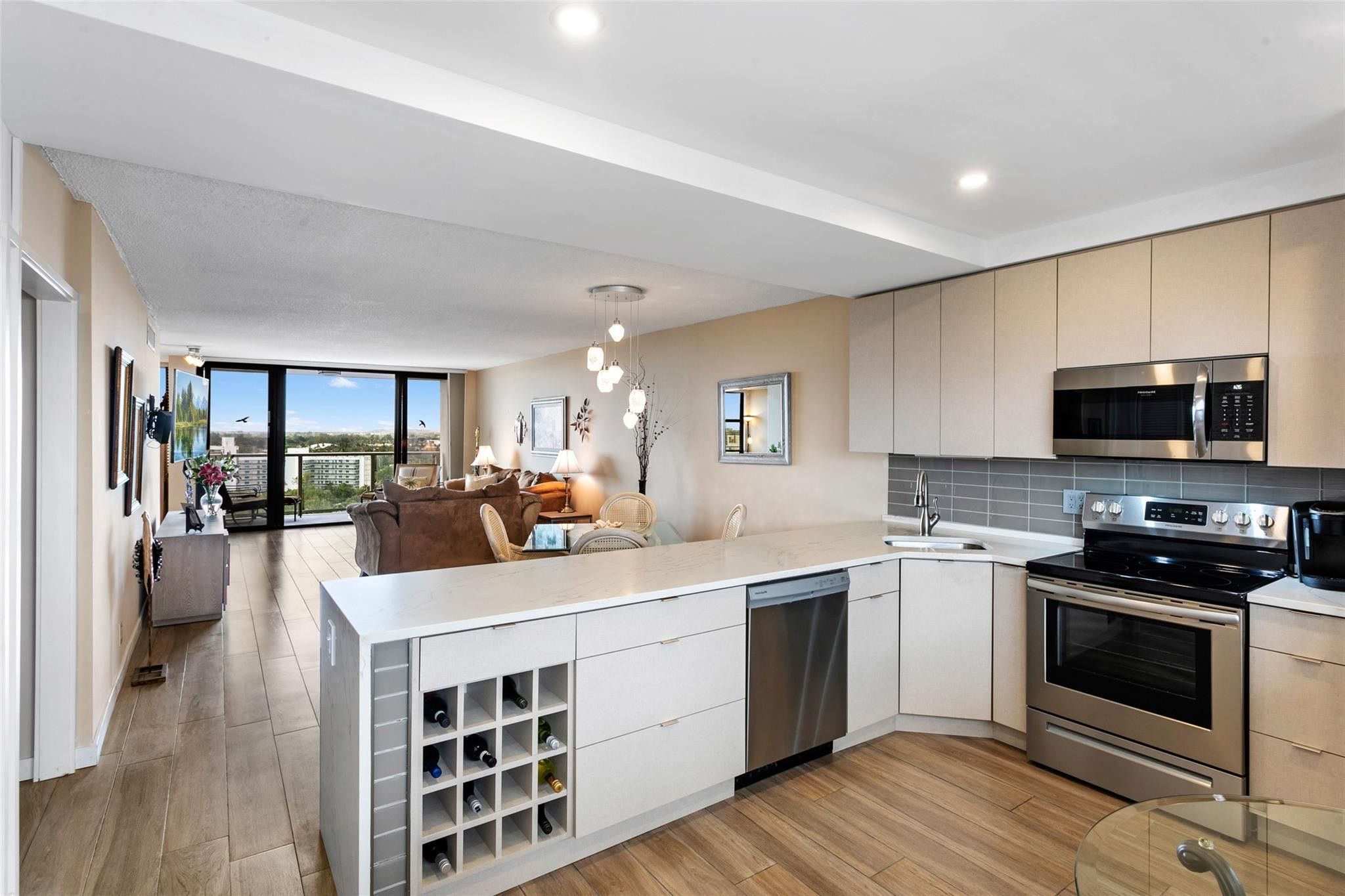 1401 North Riverside Drive, Unit PH 1502 Pompano Beach, FL 33062 - Photo 5 of 32 a kitchen with a sink stove and cabinets