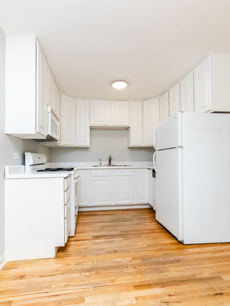 7221 Division Street, Unit 4 River Forest, IL 60305 - Photo 10 of 17 a kitchen with wooden floors and white cabinets