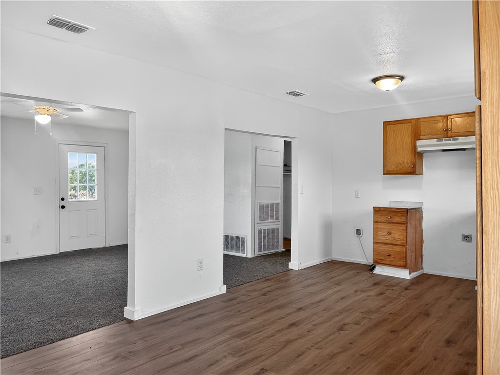 4391 Piper Cub Street Robstown, TX 78380 - Photo 11 of 40 an empty room with wooden floor and windows