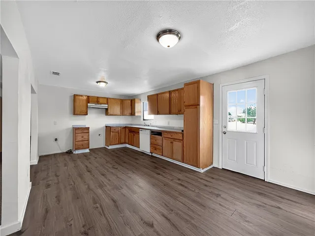 a kitchen with stainless steel appliances a refrigerator and a stove top oven