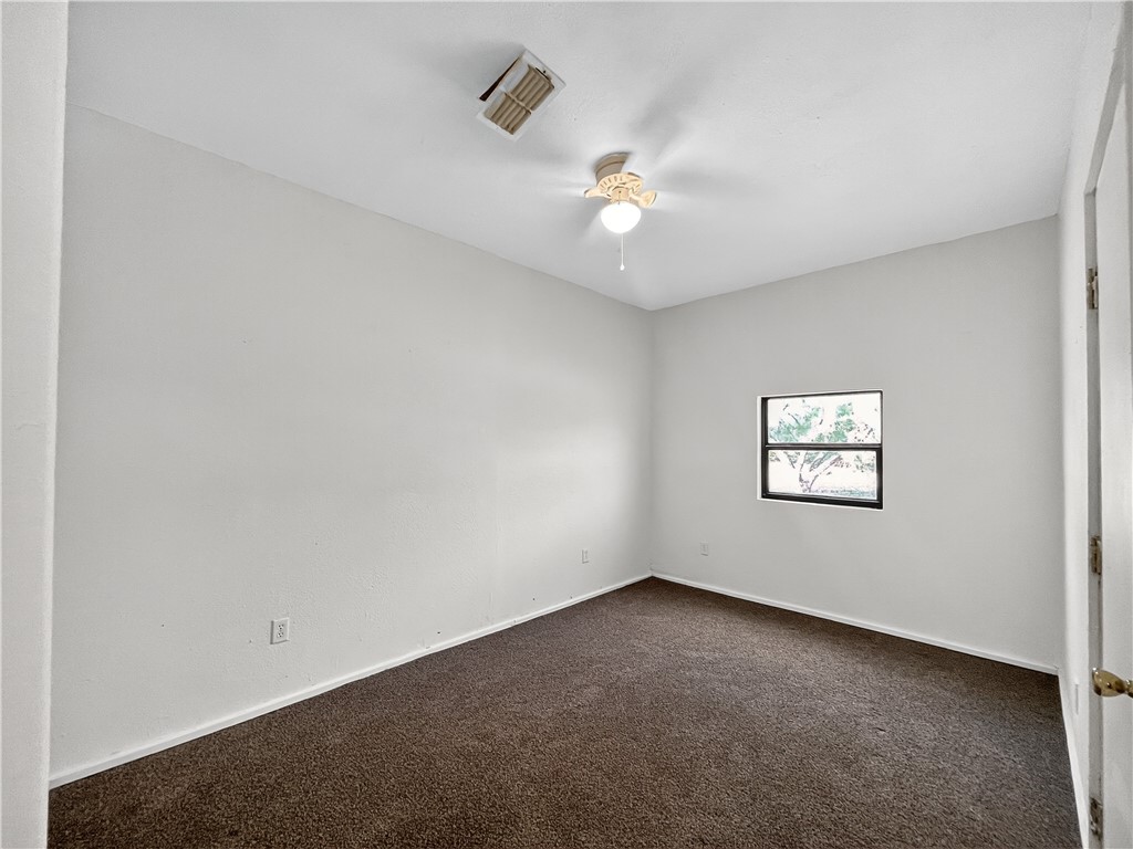 4391 Piper Cub Street Robstown, TX 78380 - Photo 14 of 40 an empty room with a window and ceiling fan