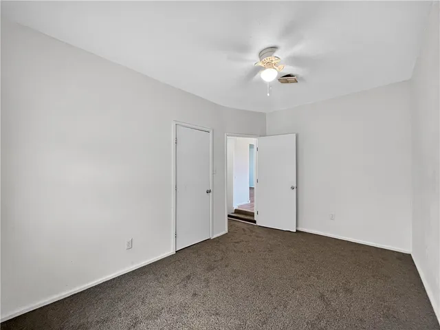 a view of a livingroom with a ceiling fan and window