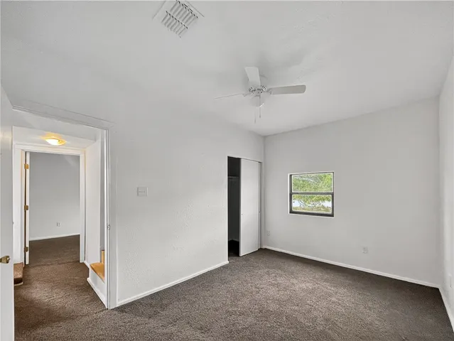 an empty room with windows and closet