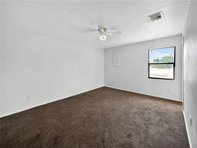 an empty room with a painting on the wall