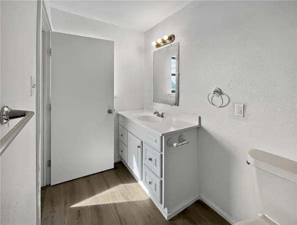 a spacious bathroom with a double vanity sink and mirror
