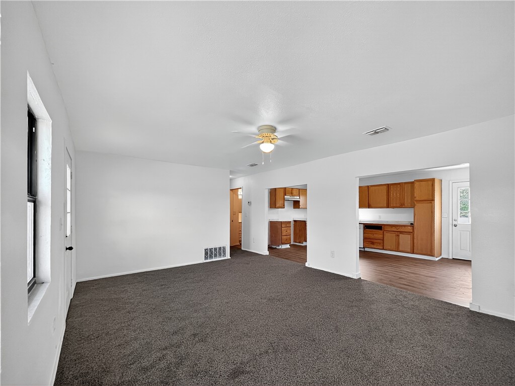 4391 Piper Cub Street Robstown, TX 78380 - Photo 7 of 40 wooden floor in an empty room with a ceiling fan
