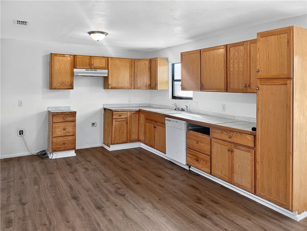 4391 Piper Cub Street Robstown, TX 78380 - Photo 10 of 40 a kitchen with stainless steel appliances granite countertop a sink cabinets and wooden floor