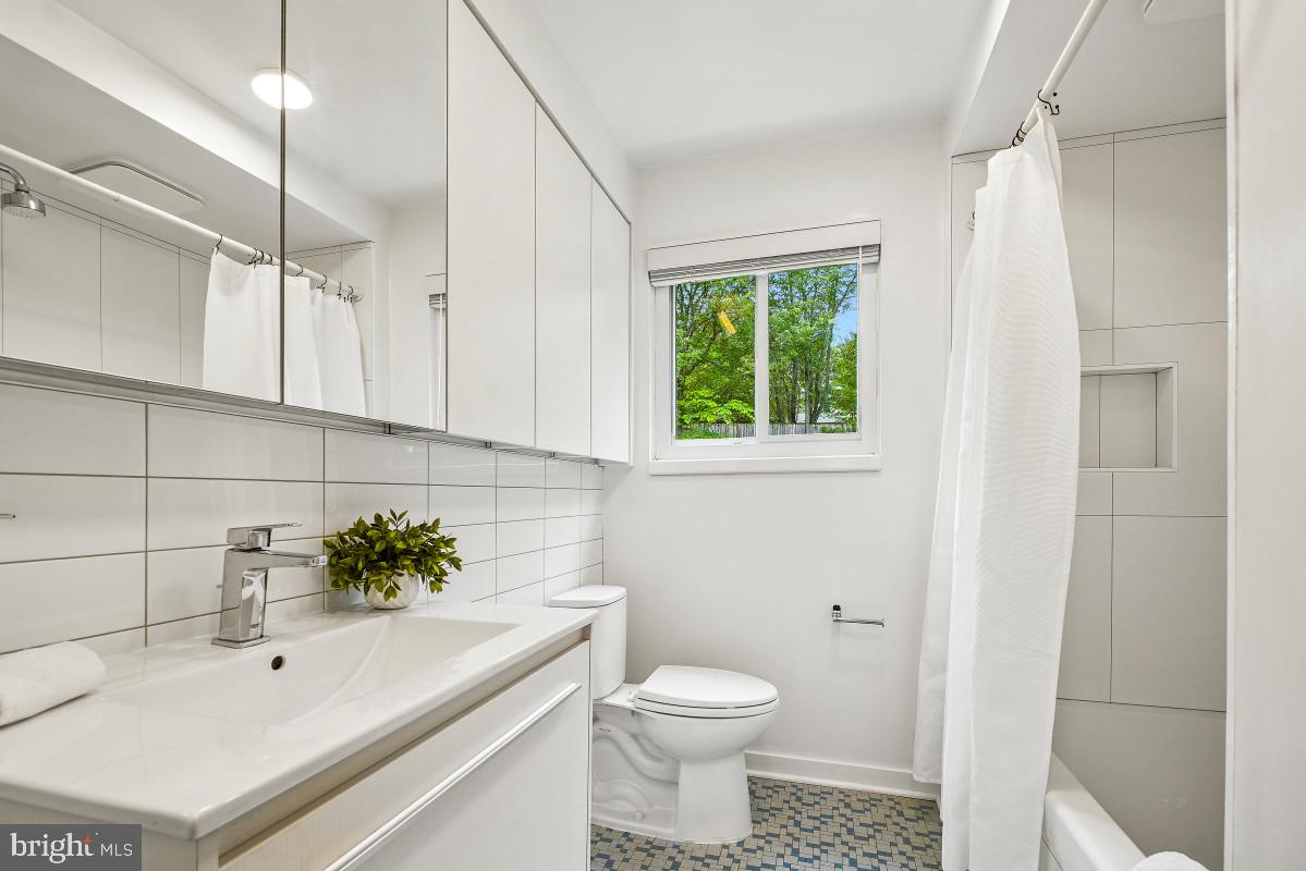 827 Caddington Avenue Silver Spring, MD 20901 - Photo 29 of 45 a bathroom with a sink a toilet and tub