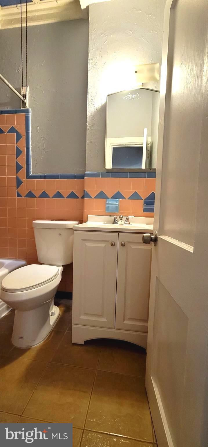 4922 North 8th Street Philadelphia, PA 19120 - Photo 11 of 21 a bathroom with a sink a toilet and mirror