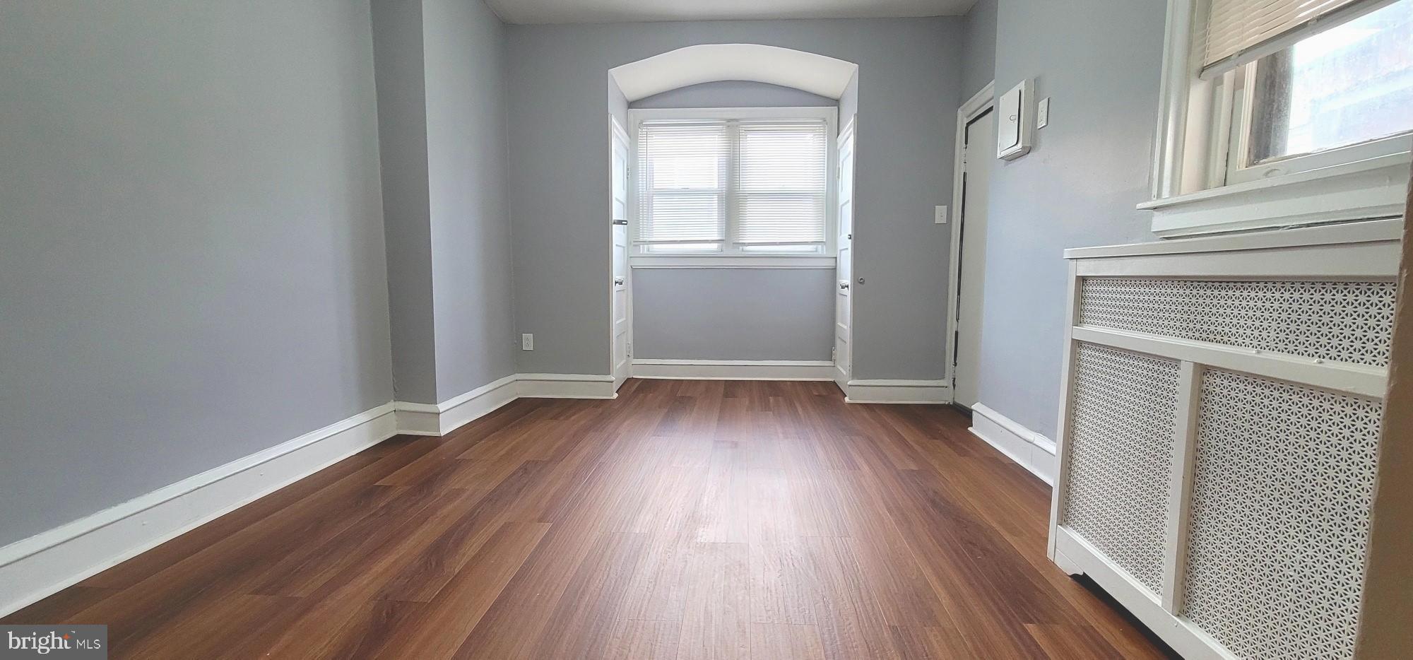 4922 North 8th Street Philadelphia, PA 19120 - Photo 13 of 21 an empty room with wooden floor and windows