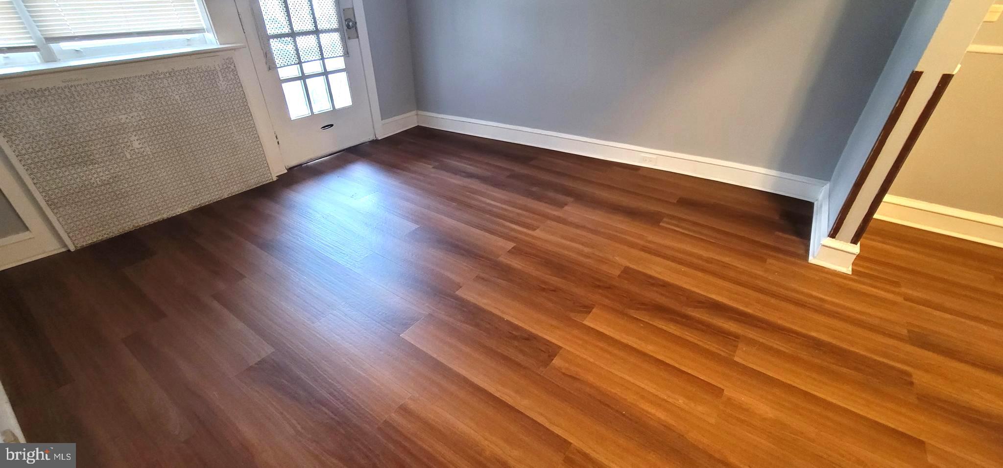 4922 North 8th Street Philadelphia, PA 19120 - Photo 4 of 21 a view of an empty room with wooden floor and a window