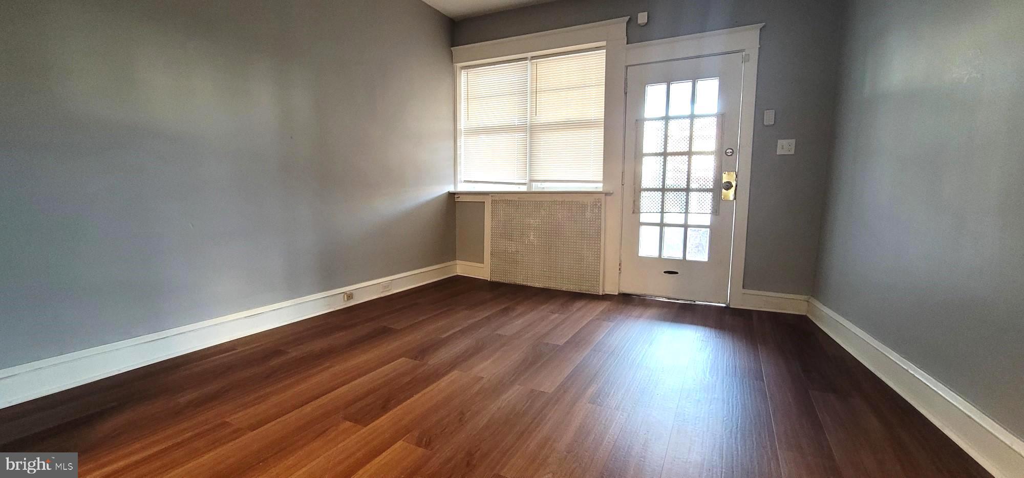 4922 North 8th Street Philadelphia, PA 19120 - Photo 5 of 21 an empty room with wooden floor and windows