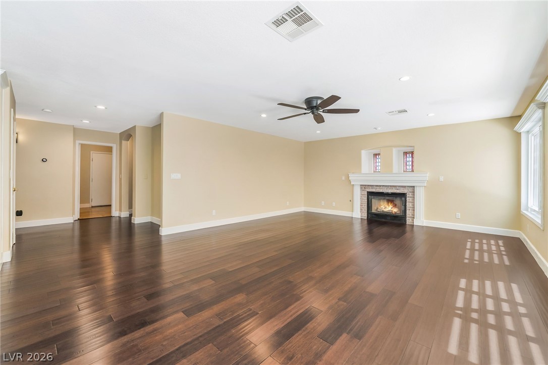 271 Pointe Ranier Avenue Henderson, NV 89012 - Photo 6 of 26 This expansive living space features rich hardwood flooring and a charming brick fireplace.