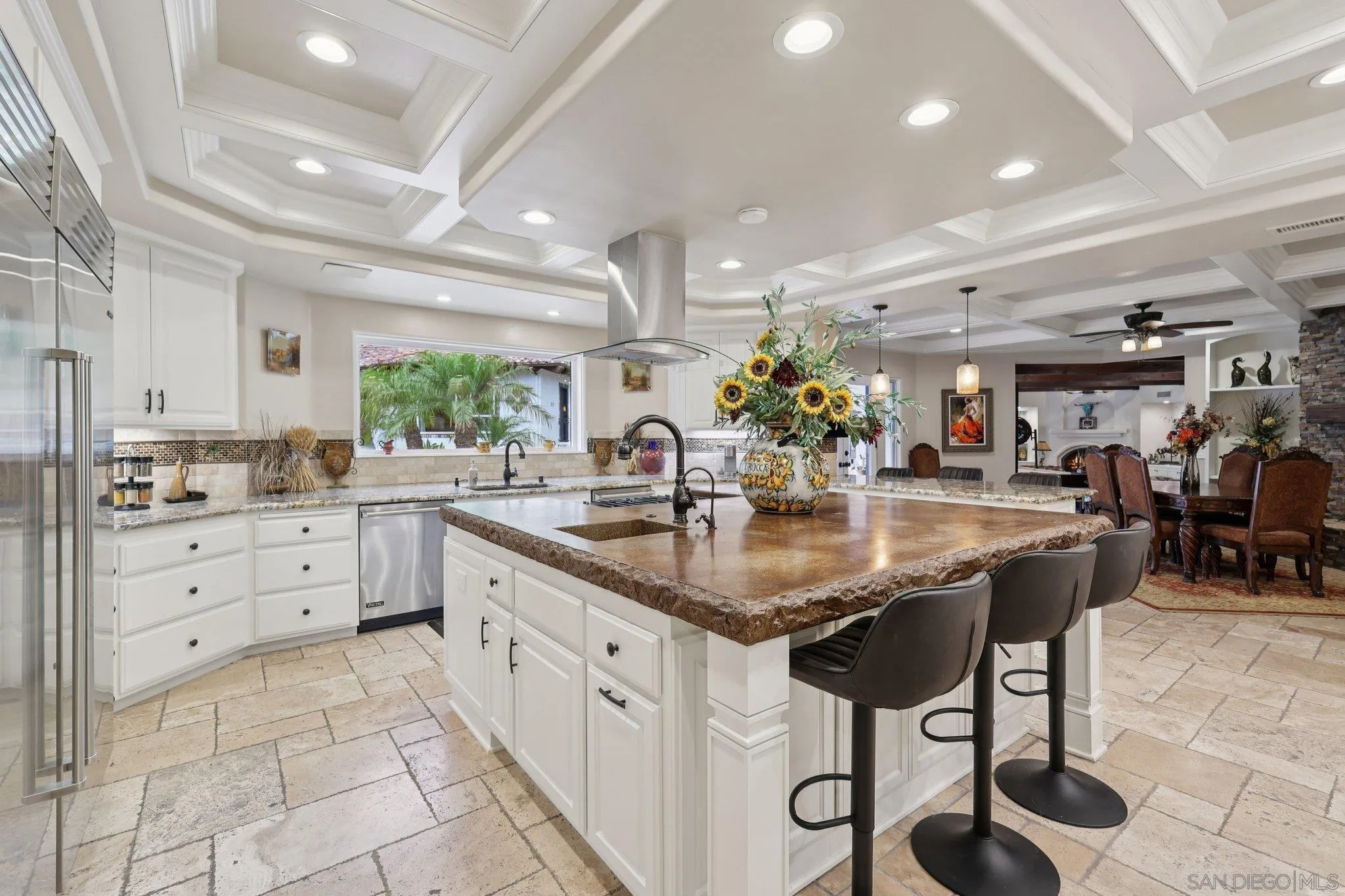 13371 Summit Circle Poway, CA 92064 - Photo 14 of 75 a kitchen with stainless steel appliances kitchen island granite countertop a table chairs and a sink