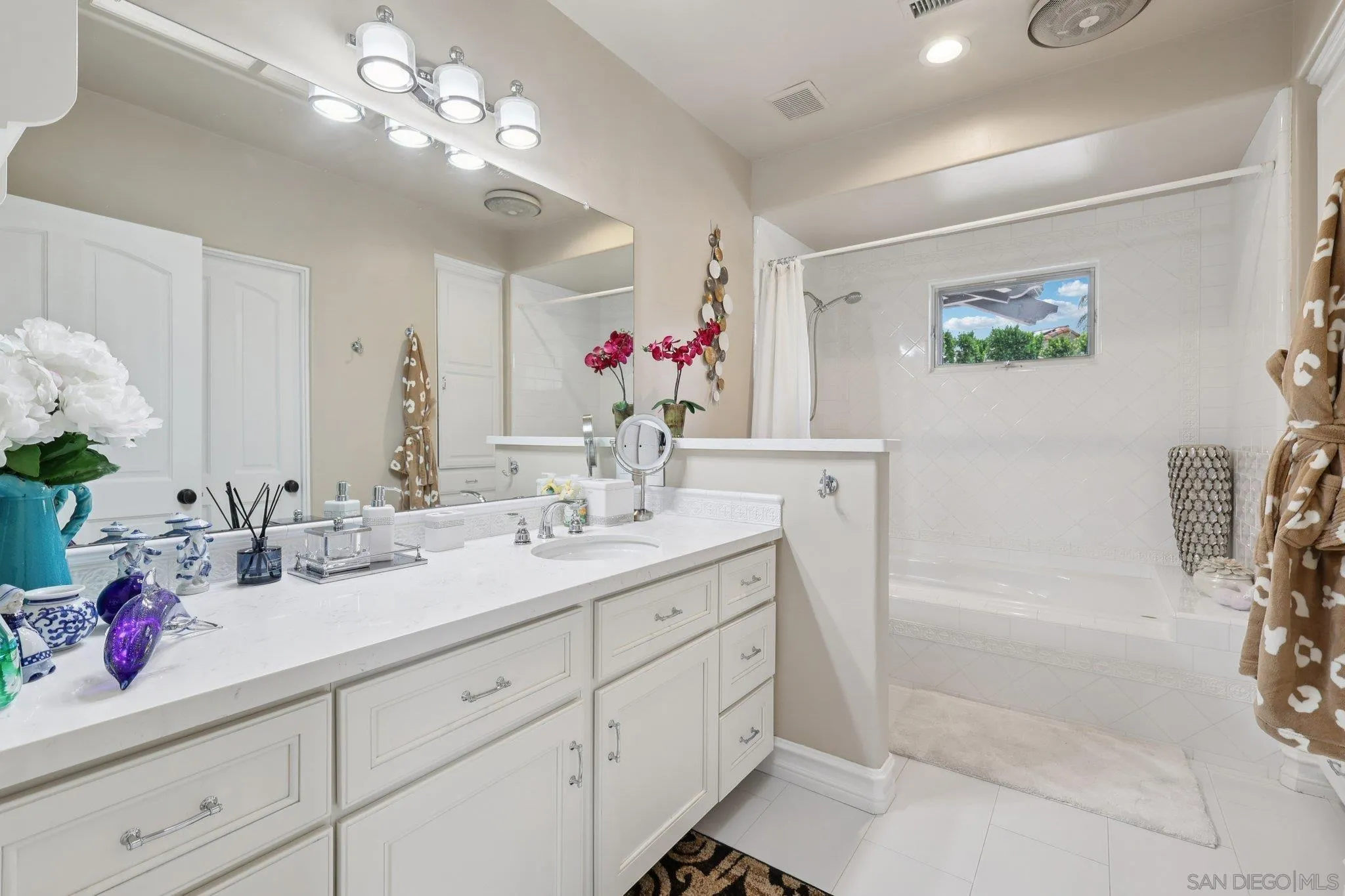 13371 Summit Circle Poway, CA 92064 - Photo 36 of 75 a bathroom with a granite countertop sink a large mirror and a shower