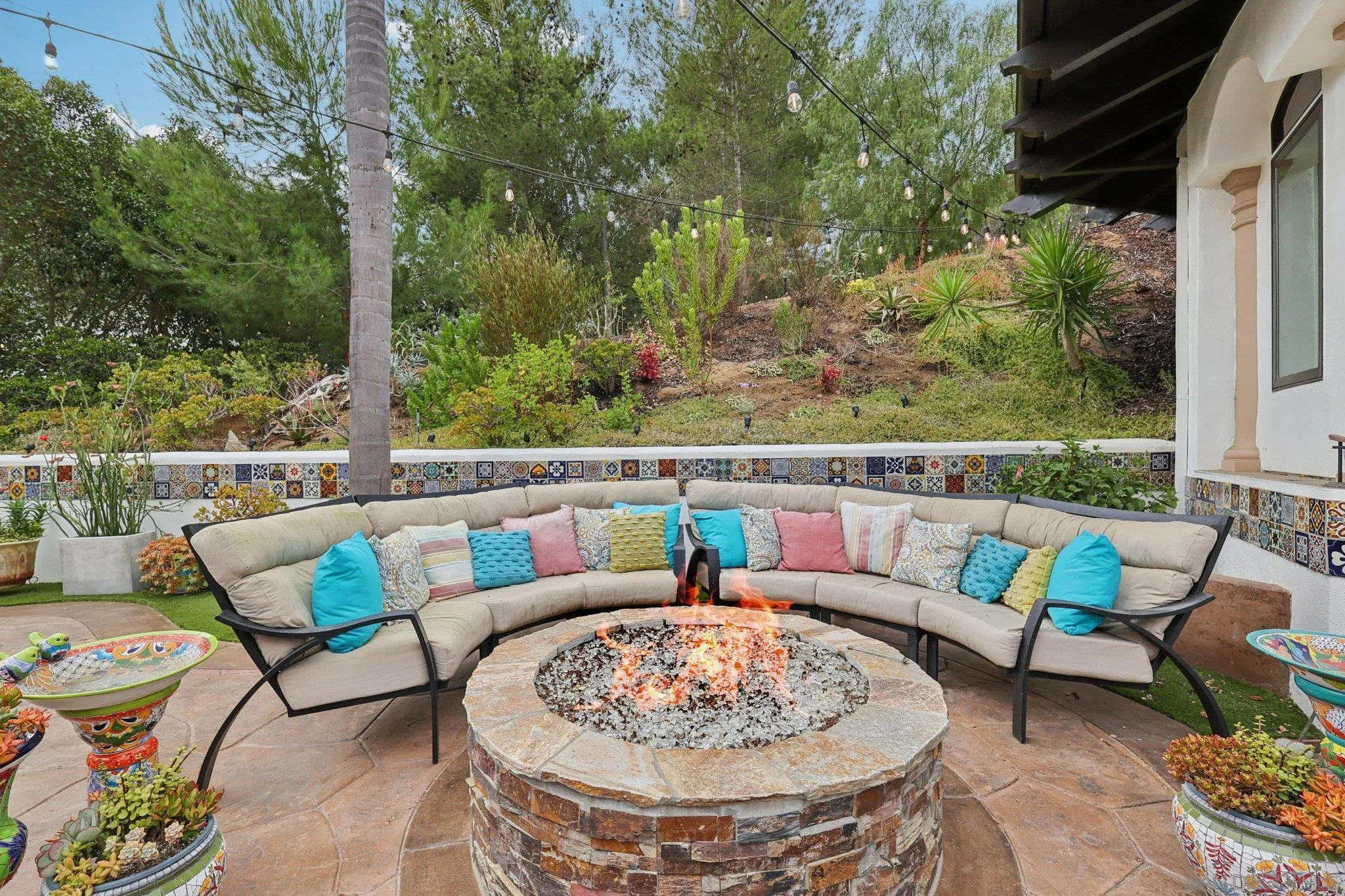 13371 Summit Circle Poway, CA 92064 - Photo 49 of 75 a view of a patio with couches table and chairs with potted plants and large trees
