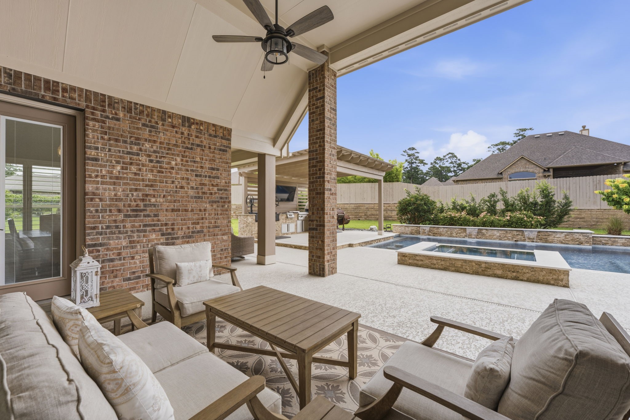 14012 Beartooth Bend Trail Conroe, TX 77384 - Photo 35 of 50 This exceptional outdoor living space offers the perfect blend of comfort and elegance. Whether savoring a glass of wine, relaxing with family, or watching the kids enjoy the pool, this inviting retreat was designed for effortless outdoor living. Seamlessly connected to the backyard oasis, this versatile space beautifully extends the home’s entertaining possibilities outdoors.
