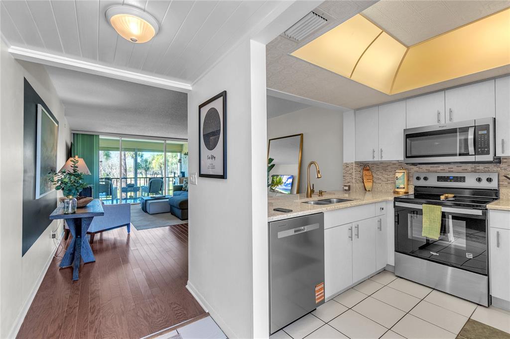 12200 Vonn Road, Unit 2206 Largo, FL 33774 - Photo 7 of 60 a kitchen with a sink a counter top space appliances and cabinets