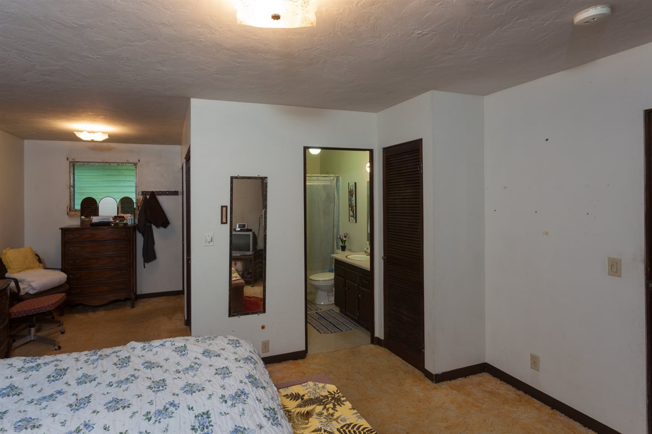 605 Kaupakalua Road Haiku, HI 96708 - Photo 17 of 30 a bedroom with a bed and a view of bathroom