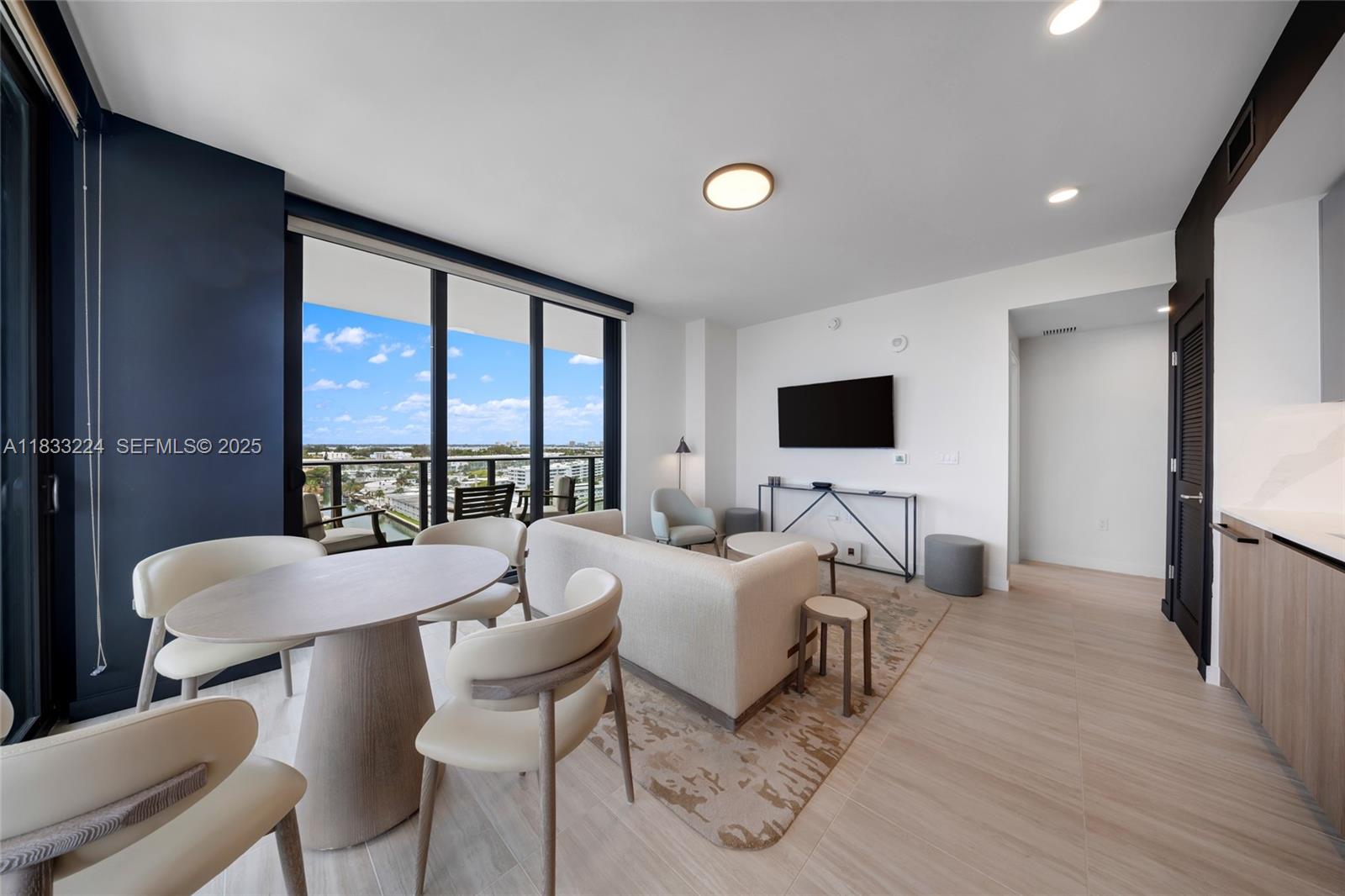 580 72nd Street, Unit 910 Miami Beach, FL 33141 - Photo 28 of 60 a living room with furniture a flat screen tv and a large window