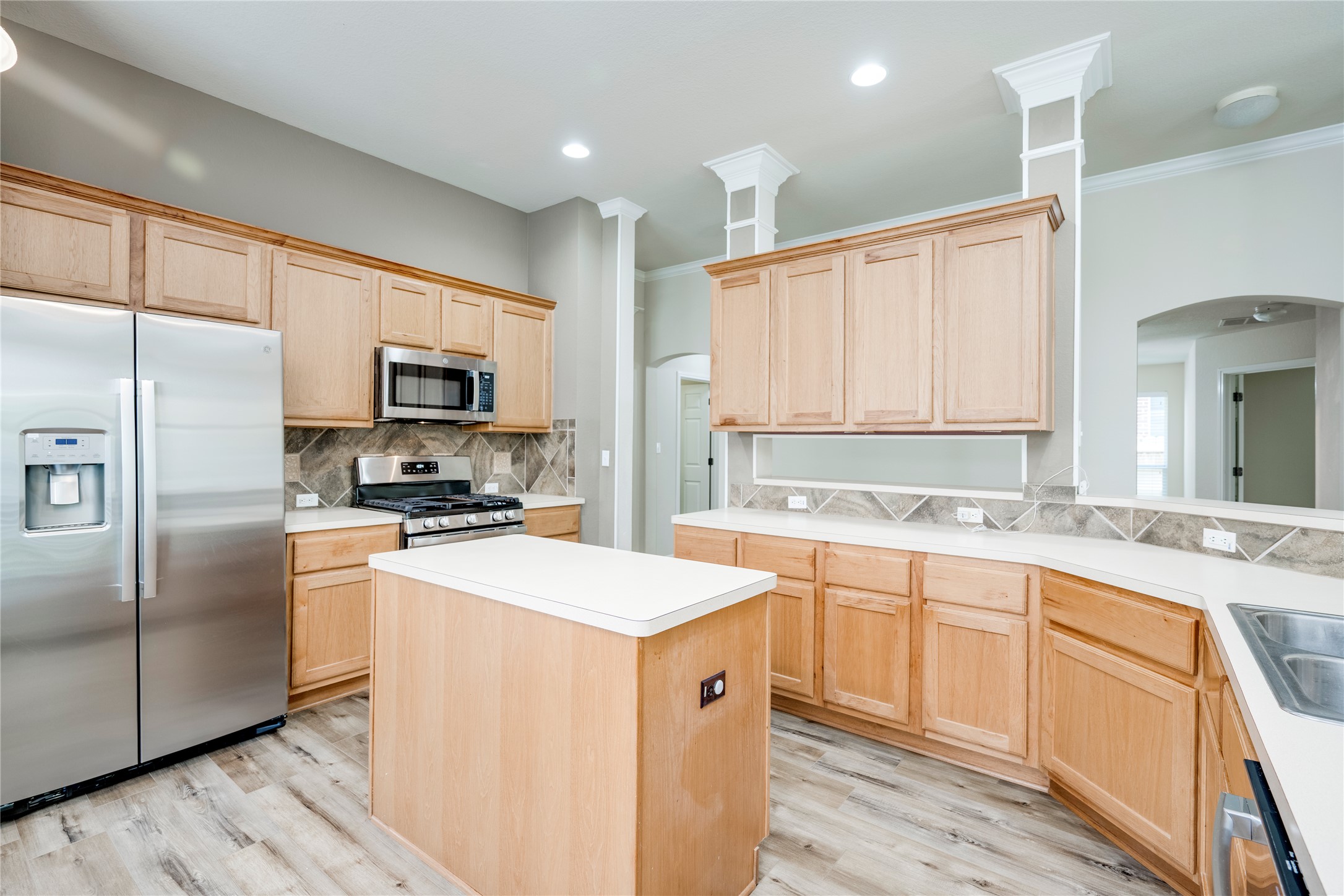 1813 Nelson Ranch Loop Cedar Park, TX 78613 - Photo 12 of 39 A well-equipped kitchen showcasing a central island and a full suite of stainless steel appliances.
