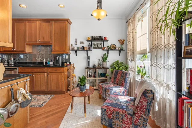 a living room with furniture a rug and a chandelier