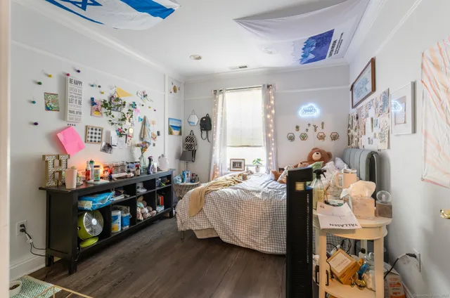 a bedroom with furniture and a wooden floor