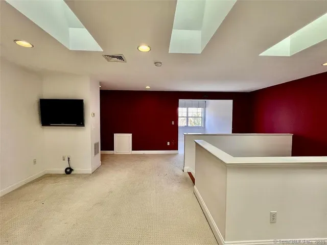 a view of an empty room with windows