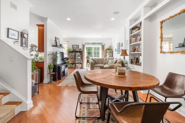 a view of a dining room with furniture and a potted plant