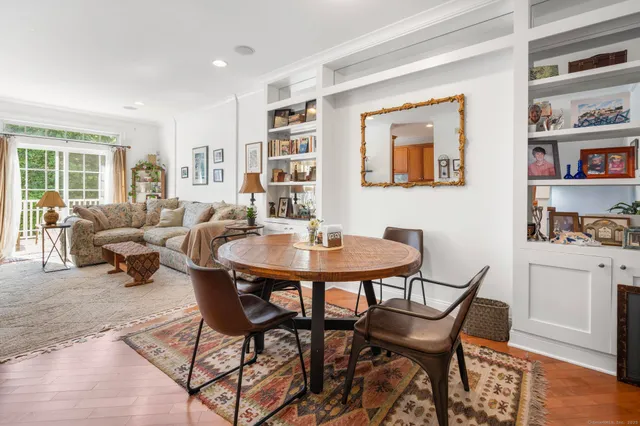 a dining room with furniture and a book shelf