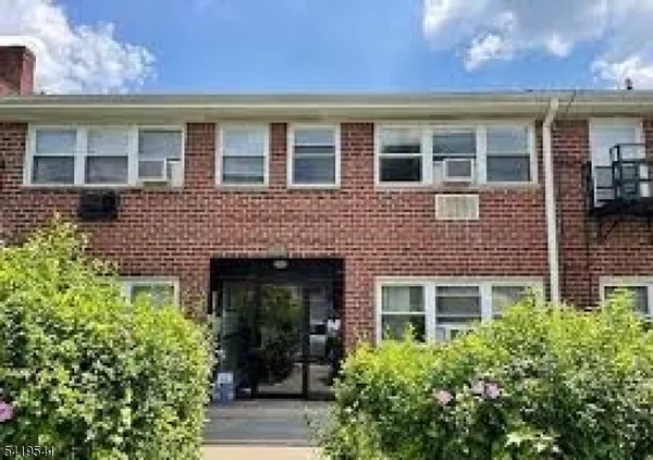front view of a brick house with a large windows