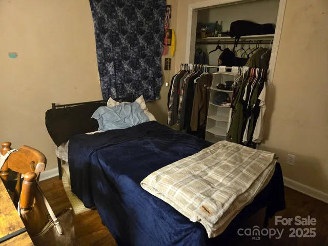 a bed sitting in a bedroom next to a window