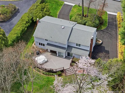an aerial view of a house with backyard space and garden