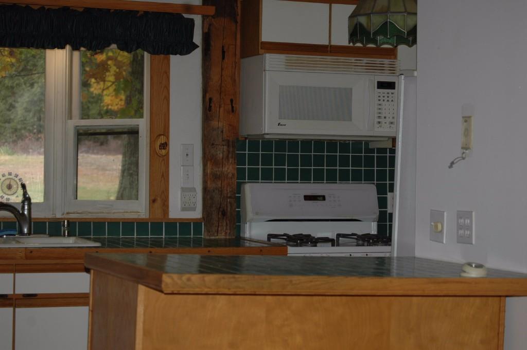 10 McDermott Road Raymond, ME 04071 - Photo 15 of 32 Gas stove in kitchen and a view of...