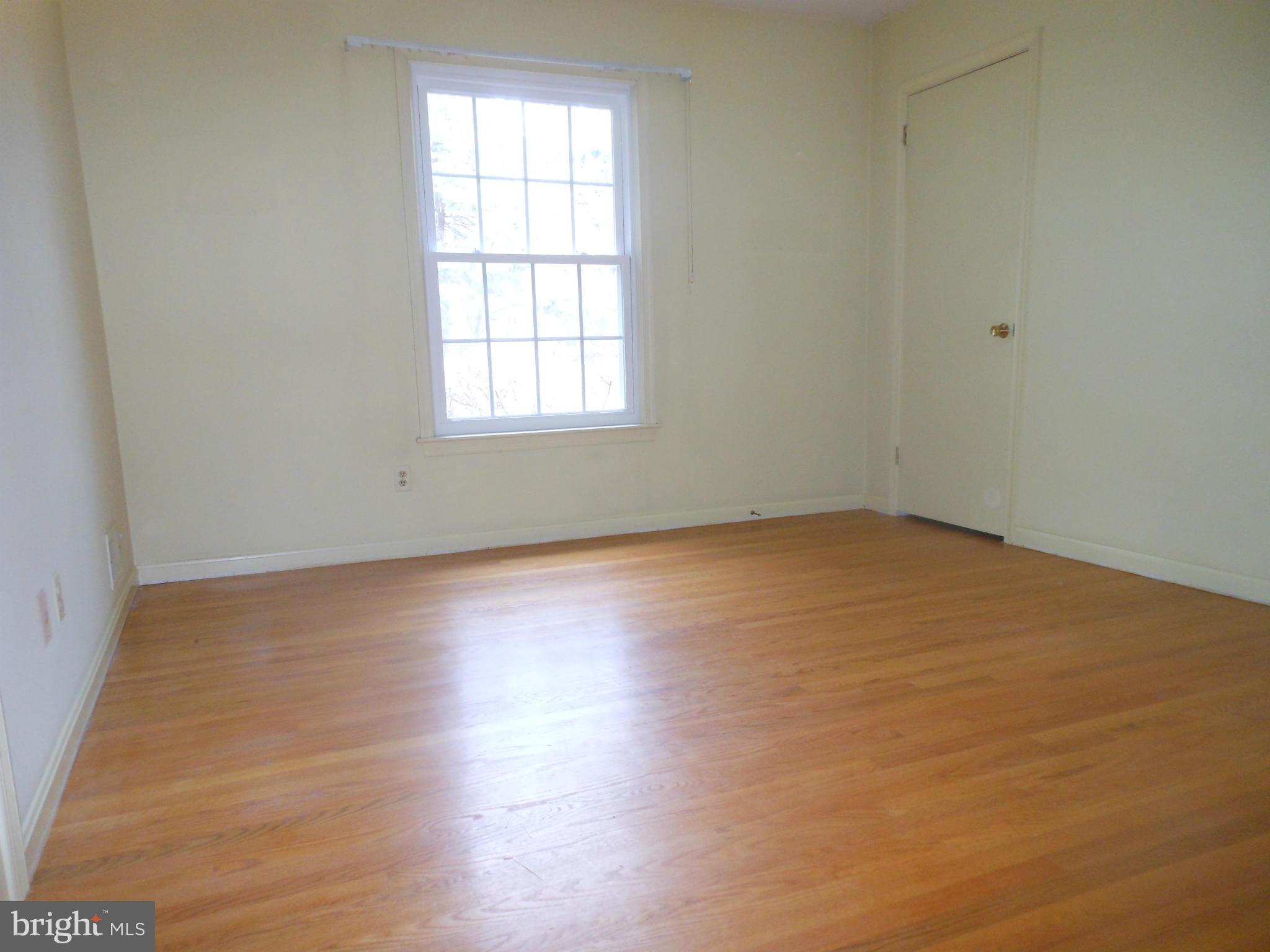 1705 Gamewell Road Silver Spring, MD 20905 - Photo 6 of 28 an empty room with wooden floor and windows