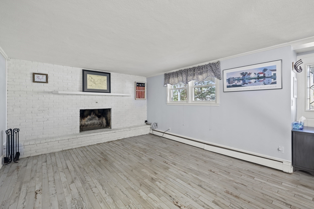 21 Reading Terrace Reading, MA 01867 - Photo 11 of 42 an empty room with windows and fireplace