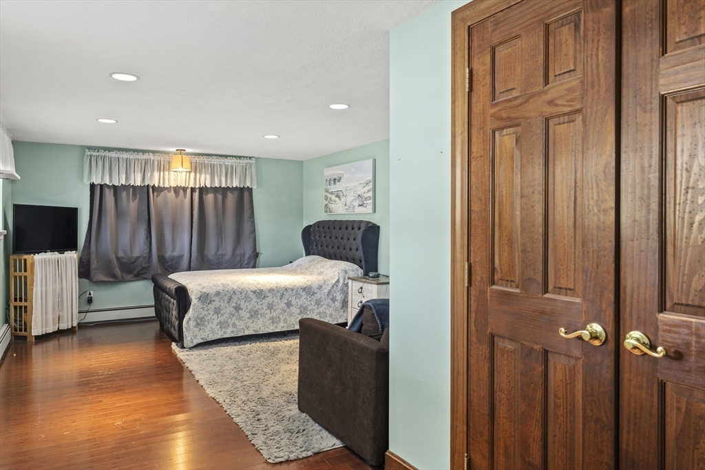 21 Reading Terrace Reading, MA 01867 - Photo 12 of 42 a bedroom with furniture and a wooden floor