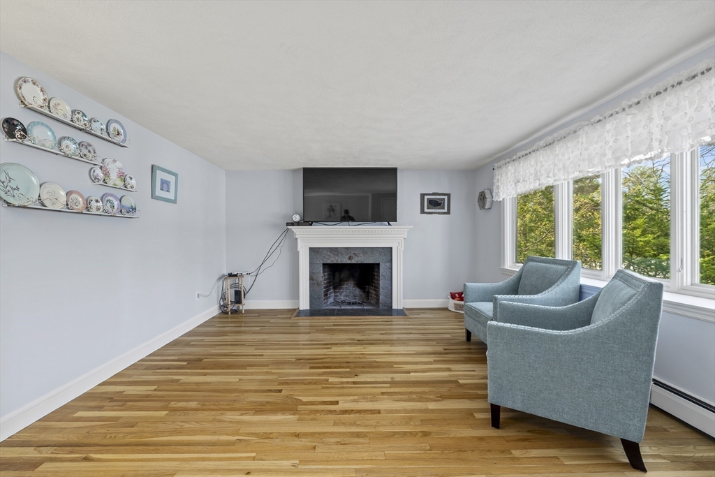 21 Reading Terrace Reading, MA 01867 - Photo 18 of 42 a living room with furniture window and a fireplace
