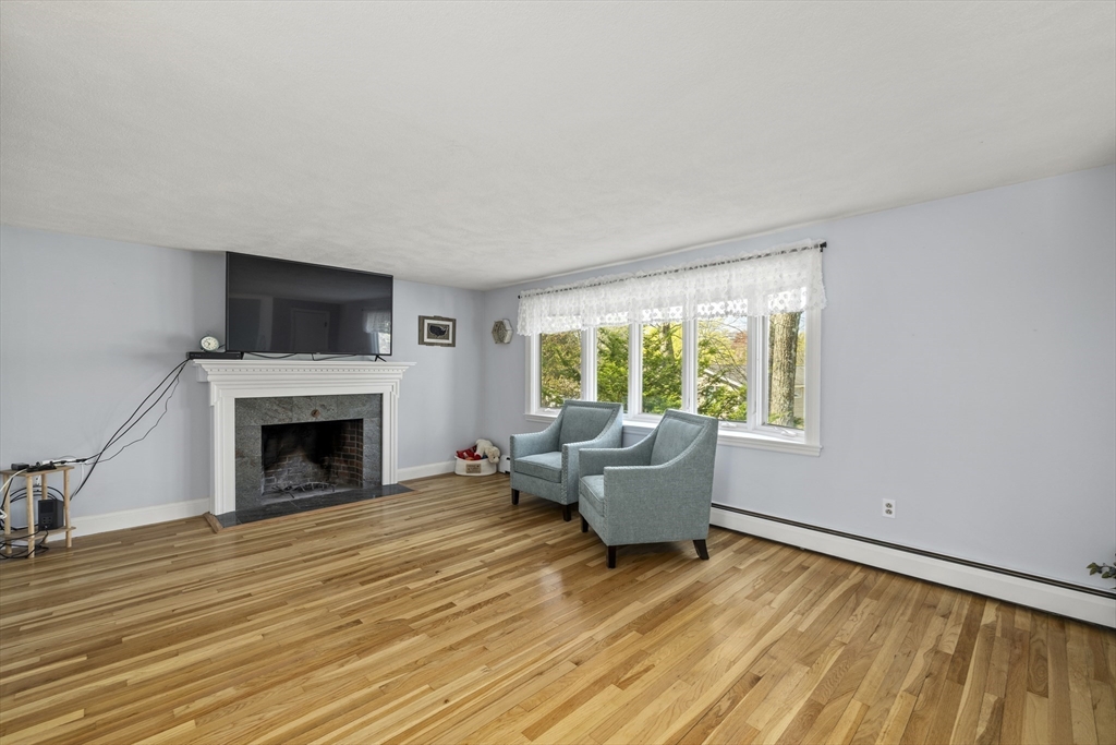 21 Reading Terrace Reading, MA 01867 - Photo 20 of 42 a living room with furniture and a fireplace