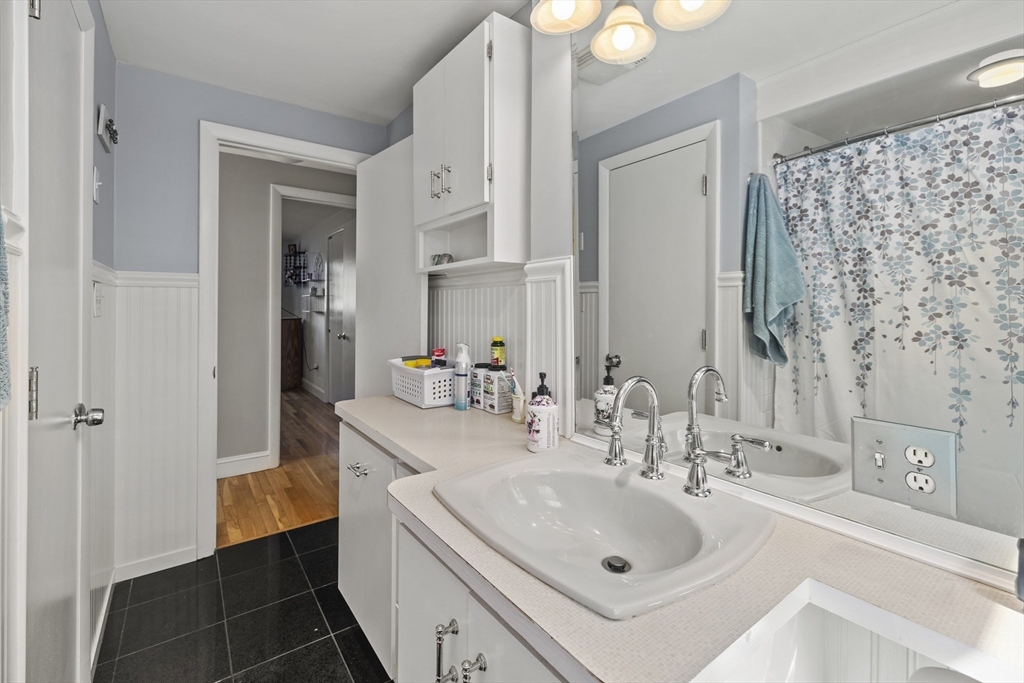21 Reading Terrace Reading, MA 01867 - Photo 25 of 42 a bathroom with a sink and a mirror