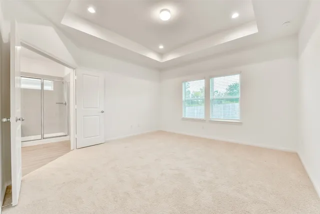 an empty room with windows and closet