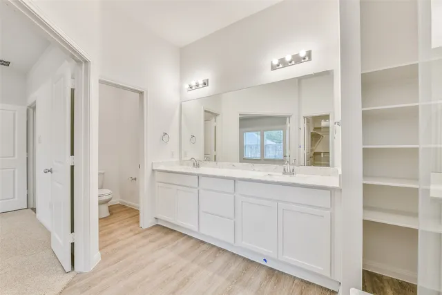 a bathroom with a granite countertop sink mirror and shower