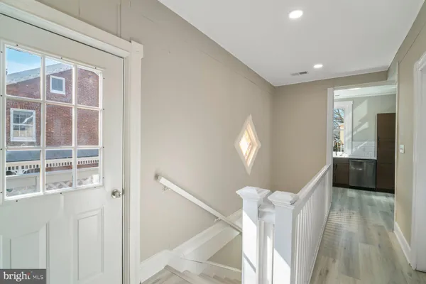a view of a hallway with furniture and windows