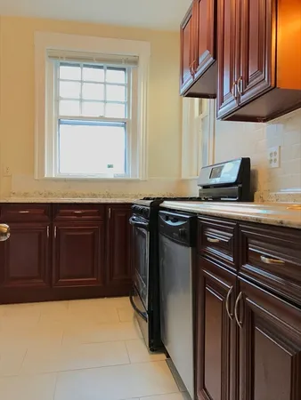 a kitchen with granite countertop a sink and a stove